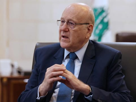 Lebanon's caretaker prime minister Najib Mikati speaks during an interview with AFP at his office in Beirut on October 30, 2023.  