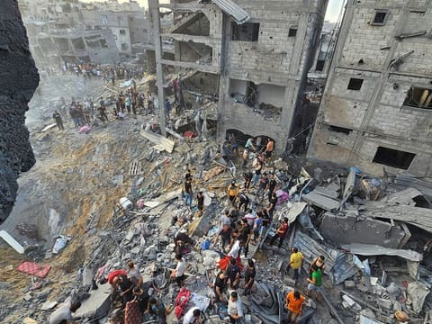 Palestinians search for casualties at the site of Israeli strikes on houses in Jabaliya refugee camp in the northern Gaza Strip.