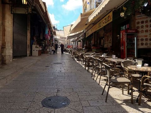 People walk into Jerusalem's Old City via Jaffa Gate, as the ongoing Gaza war wreaks havoc across the tourism sector