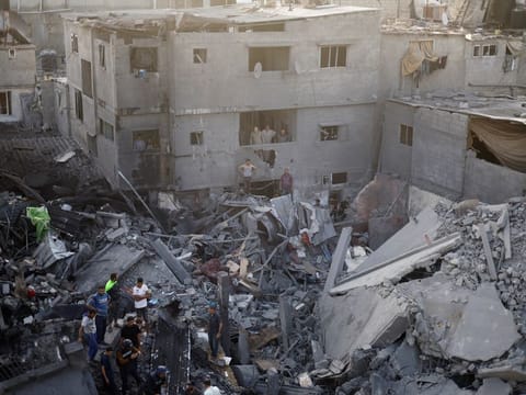 Palestinians search for casualties, at the site of Israeli strikes on houses, amid the ongoing conflict between Israel and Palestinian Islamist group Hamas, at the Magazi Refugee Camp, in central Gaza Strip, November 5, 2023.  Israel’s military campaign in Gaza since October 7 has killed 9,488 people, most of them women and children, the Hamas-run health ministry says.