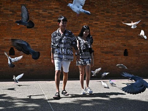 A Thai couple wearing elephant print clothing near Thapae Gate in the northern Thai province of Chiang Mai.