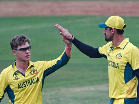 Australia's Adam Zampa (left) celebrates with teammate Mitchell Starc after taking the wicket of Afghanistan's Azmatullah Omarzai on Tuesday.