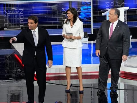 Republican presidential candidates Florida Gov. Ron DeSantis, former UN Ambassador Nikki Haley and former New Jersey Gov. Chris Christie walk on stage after a Republican presidential primary debate hosted by NBC News, Wednesday, Nov. 8, 2023, at the Adrienne Arsht Center for the Performing Arts of Miami-Dade County in Miami. 