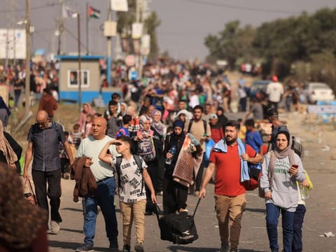 Palestinians families fleeing Gaza City and other parts of northern Gaza towards the southern areas, walk along a highway on November 9, 2023, amid the ongoing battles between Israel and the Palestinian Islamist group Hamas.  