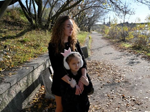 Anna Lyashko, 28, and her daughter Diana, 8, walk in a park near Dnipro river in Kyiv amid the Russian attacks on Ukraine.  