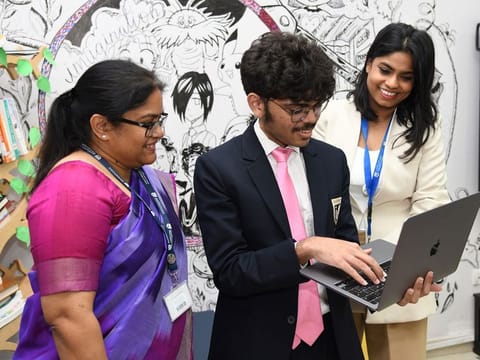 Aadivya Raushan (centre) explaining the working of his AI lesson plan generator to his thrilled teachers in Dubai.