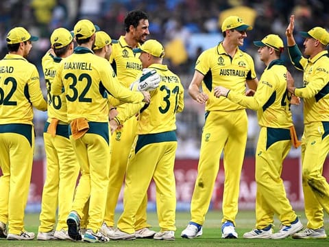 Australia's David Warner (C) celebrates with teammates after taking the catch to dismiss South Africa's Aiden Markram during the 2023 ICC Men's Cricket World Cup second semi-final match against South Africa at the Eden Gardens in Kolkata on November 16, 2023.  