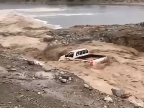 Video grab of a vehicle swept away in a flooded Fujairah valley on Friday morning.