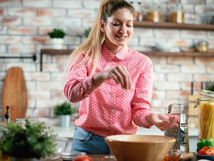 Woman putting salt