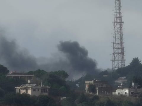 Black smoke rises from an Israeli army position which was hit by Hezbollah heavy missiles, as it was seen from Rmeish, a Lebanese border village with Israel in south Lebanon, on November 20, 2023.  