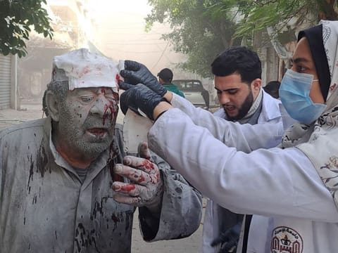 A Palestinian man receives first-aid after an Israeli strike near the Kamal Adwan hospital in Beit Lahia in the northern Gaza Strip on November 22, 2023.  