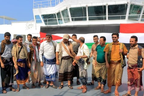 A picture taken during an organised tour by Yemen's Houthi rebels on November 22, 2023 shows the group's minister of information, Dhaifallah Al Shami (4th left), inspecting the Galaxy Leader Cargo ship, seized by militants two days earlier, whiled docked at a port on the Red Sea in Yemen's province of Hodeida with the Palestinian (left) and Yemeni flags in the background. The Bahamas-flagged, British-owned Galaxy Leader, operated by a Japanese firm but having links to an Israeli businessman, was headed from Turkey to India when it was seized and re-routed to Hodeida November 19, according to maritime security company Ambrey.  