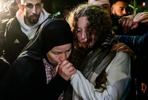 Ahed Tamimi (right) is greeted by relatives during a welcome ceremony following the release of Palestinian prisoners from Israeli jails in exchange for Israeli hostages held in Gaza by Hamas since the October 7 attacks, in Ramallah in the West Bank early on November 30, 2023.  