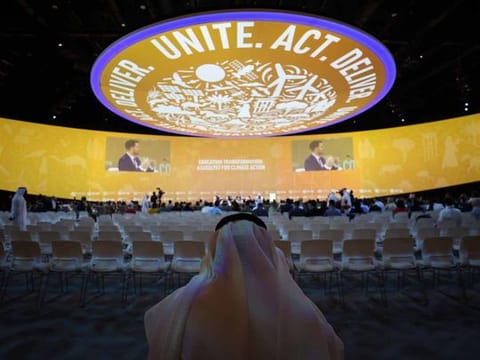 An attendee inside a panel session on day three of the COP28 climate conference at Expo City in Dubai, United Arab Emirates, on Saturday, Dec. 2, 2023.