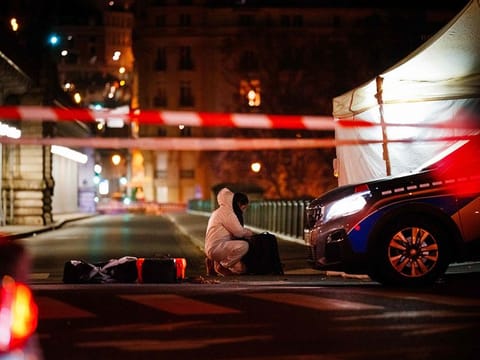 A forensic police officer works at the scene of a stabbing in Paris