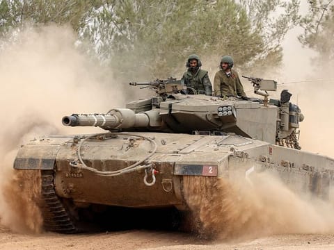 An Israeli military tank rolls near the border with the Gaza Strip on December 5, 2023, amid continuing battles between Israel and the militant group Hamas.