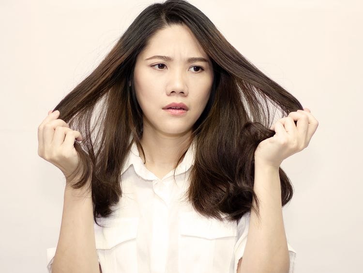 Woman pulling her hair