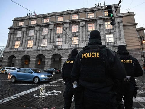 Police officers are seen in and around the Charles University in central Prague, on December 22, 2023, police investigators kept working on the campus the day after a deadly mass shooting.