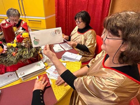 Kornelia Matzke, right, and her colleagues prepare thousands of replies, each with a special stamp in Himmelpfort, Germany, on December 21. 