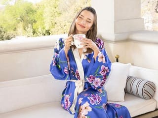 Supermodel Miranda Kerr flaunts her baby bump in festive dress
