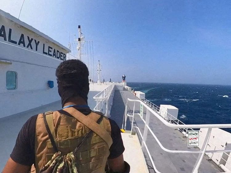 An Al Houthi militant stands on the Galaxy Leader cargo ship in the Red Sea in this photo released November 20, 2023.  