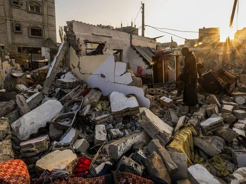 Residents search in the rubble of a house destroyed by Israeli bombardment in Rafah refugee camp, south of the Gaza Strip, on January 1, 2024, amid the ongoing conflict between Israel and the Palestinian militant group Hamas. 