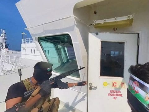 Al Houthi militants on a ship's deck in the Red Sea in this photo released November 20, 2023.  In recent weeks, Al Houthi militants have launched a flurry of drone and missile strikes targeting commercial vessels transiting the Red Sea and the Bab Al Mandab Strait that connects the Red Sea to the Gulf of Aden.