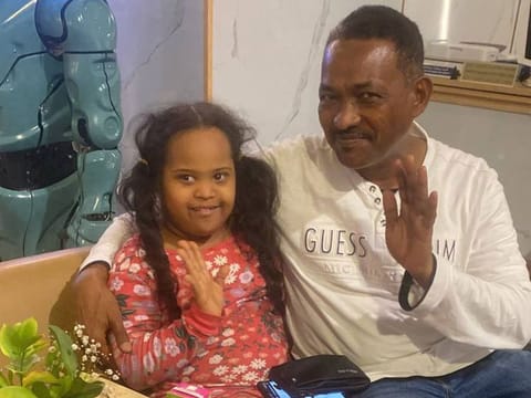 Nine-year-old girl who was found by Ajman Police, posing for a photograph with her father