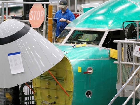 File photo: An employee works outside the cockpit of a Boeing 737 MAX 8 airplane in the company's factory in Renton, Washington. 