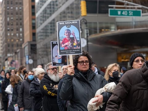 People participate in a silent march and protest in midtown Manhattan against the deaths of Palestinians in Gaza 