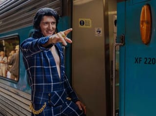 Sideburns, sweat and blue suede shoes on pop legend Elvis Presley train in Australia