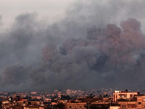 This picture taken from Rafah shows smoke billowing over Khan Younis in the southern Gaza Strip during Israeli bombardment on January 16, 2024.