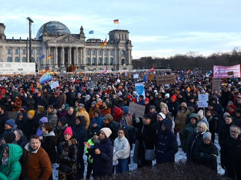Participants gather during a demonstration against racism and far right politics in front of the Reichstag building in Berlin on January 21, 2024.  