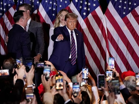 Former U.S. President and Republican presidential candidate Donald Trump gestures to the crowd during a New Hampshire presidential primary election night watch party, in Nashua, New Hampshire, U.S., January 23, 2024
