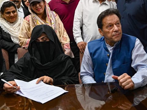 Pakistan's former Prime Minister, Imran Khan along with his wife Bushra Bibi during the signing of surety bonds for bail in various cases, at a registrar office in the High court, in Lahore on July 17, 2023.  