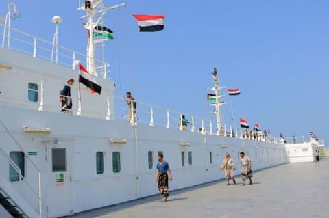 A picture taken during an organised tour by Yemen's Houthi militants (on board) on November 22, 2023 shows the Galaxy Leader cargo ship, seized by the militiamen two days earlier, docked in a port on the Red Sea in the Yemeni province of Hodeida, with Palestinian and Yemeni flags installed on it.  