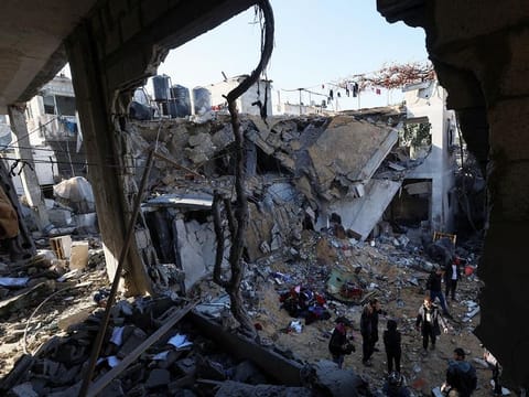 Palestinians inspect the site of an Israeli strike in Rafah in the southern Gaza Strip on February 3, 2024. 
