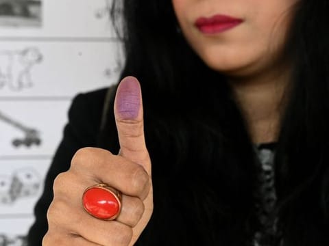A woman casts her ballot at a polling station in Islamabad on February 8, 2024.  