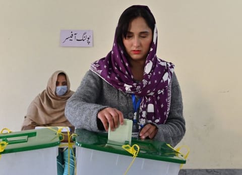 A woman casts her ballot at a polling station in Islamabad on February 8, 2024.  