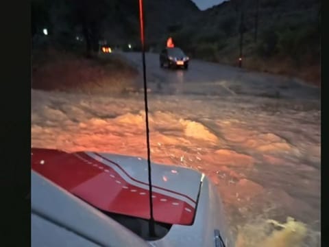 Image from Dubai Police showing floodwaters over a road after heavy rains in Hatta  