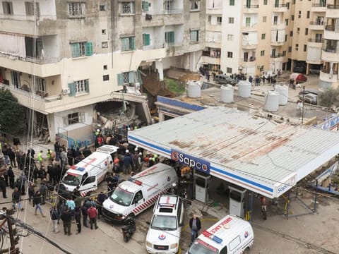 People gather near ambulances at a damaged site of what security sources said was an Israeli strike in Nabatieh, southern Lebanon, on February 15, 2024.  