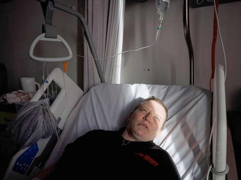 Lydie Imhoff lies on her bed in a hospital room in Belgium, on February 1, 2024 as she waits for the doctor to arrive on the day of the euthanasia. Lydie Imhoff, a 43 year-old French citizen suffering from hemiplegia and blindness from birth due to a perinatal stroke, has been authorised to travel from Besancon, France, to Belgium to undergo euthanasia on February 1, 2024.  