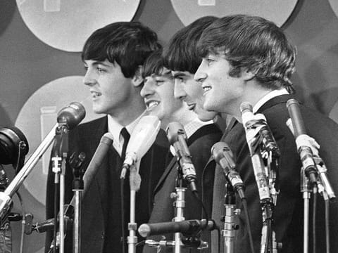 File photo: The Beatles address the media in the press room of Kennedy International Airport on their arrival, February 7, 1964 in New York.  The Beatles are getting the big-screen biopic treatment in not just one but a Fab Four of movies that will give each band member their own film, all of which are to be directed by Sam Mendes.  