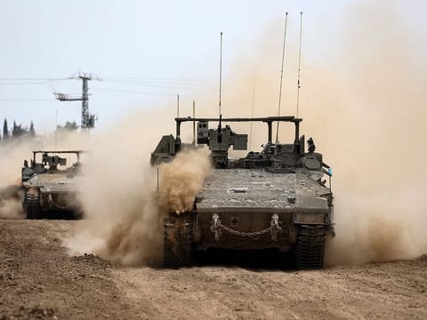 Israeli tanks roll along the border with the Gaza Strip on February 23, 2024
