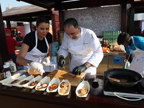 Chefs preparing food for visitors at Taste of Dubai.