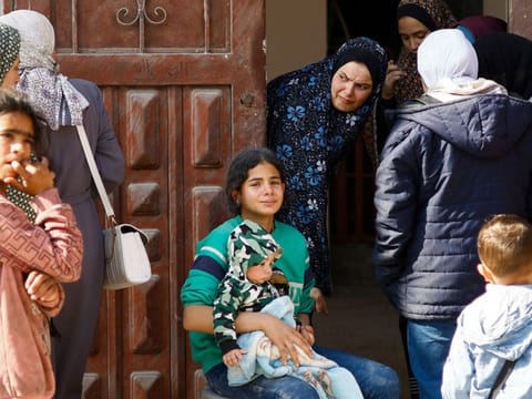 Palestinians react in the aftermath of an Israeli strike in Rafah on February 24, 2024.  