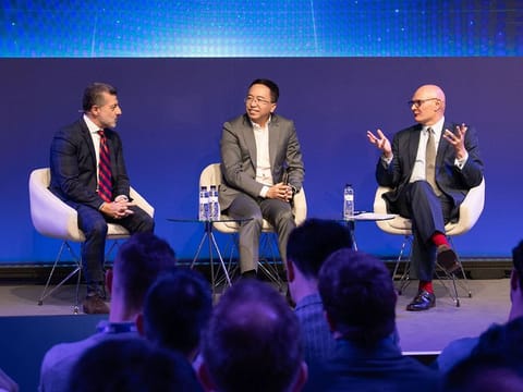 From left: Alex Katouzian, Group GM of MCX at Qualcomm Technologies, Inc., George Zhao, CEO of HONOR Device Co., Ltd., and John Hoffman, CEO of GSMA Ltd., during a panel discussion on AI at MWC 2024 in Barcelona.