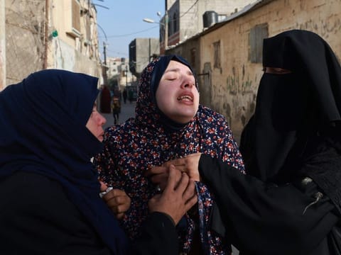 Rania Abu Anza (centre), the mother of twin babies Naeem and Wissam, killed in an overnight Israeli air strike, ahead of their burial in Rafah in the southern Gaza Strip on March 3, 2024.  