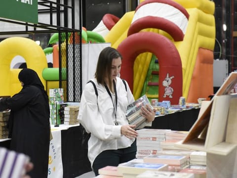 A visitor looking for books at the Big Bad Wolf in Dubai