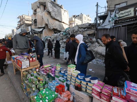 Palestinians walk past stalls set up in a street in Rafah, in the southern Gaza Strip on March 10, 2024, as Muslims prepare for Ramadan amid ongoing battles between Israel and the Palestinian militant group Hamas.  